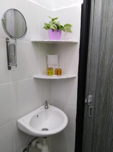 a bathroom with a sink and a mirror at D' Surya Lavender Inn in Pantai Cenang