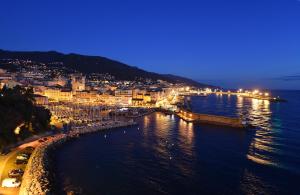 an aerial view of a city at night at Hôtel Des Gouverneurs in Bastia