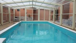 an indoor swimming pool with a glass ceiling and a pool at Villa Salvatore in San Leone