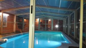 a swimming pool in a house with a large window at Villa Salvatore in San Leone