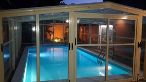 a swimming pool inside a house with glass doors at Villa Salvatore in San Leone