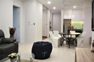 a living room with a couch and a table and chairs at Azure Residence in Petaling Jaya