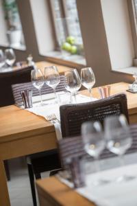 a group of wine glasses sitting on a table at Hotel Le Moulin Simonis in Laforêt