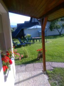 a backyard with a picnic table and some flowers at Privat Em & Mi in Liptovský Mikuláš