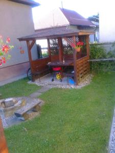 a gazebo with a picnic table in a yard at Privat Em & Mi in Liptovský Mikuláš