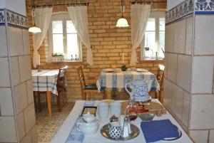 a dining room with a table with a blue and white table cloth at Lusatia Farm in Leśna