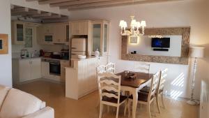 a kitchen and dining room with a table and chairs at Villa Elena in Ornos