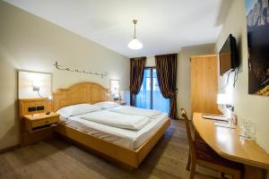 Postel nebo postele na pokoji v ubytování Hotel Touring