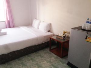 a hotel room with a bed and a table at is boutique huahin hotel in Hua Hin