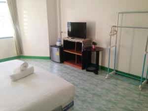 a hotel room with a bed and a television at is boutique huahin hotel in Hua Hin