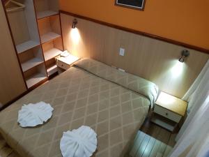 
a bedroom with a bed and a dresser at Hotel Catedral in Mar del Plata
