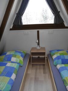 Krevet ili kreveti u jedinici u objektu Ferienhaus im Nordschwarzwald - Nurdachhaus in Waldrandlage