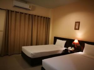 A bed or beds in a room at Kong Garden View Resort Chiang Rai