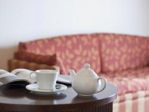 a coffee cup sitting on top of a coffee table at Hotel Manganelli Palace in Catania