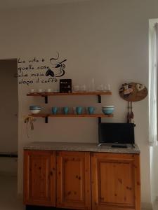 a kitchen with a counter with bowls on the wall at Holy Lake in Ghiffa