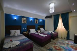 Postel nebo postele na pokoji v ubytování Amin Hotel