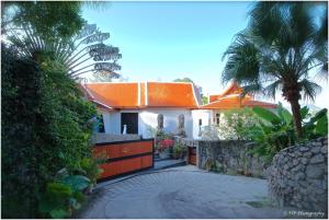 a house with an orange roof and a driveway at Villa REGTUK in Patong Beach