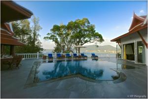 a swimming pool in a house with a view of the water at Villa REGTUK in Patong Beach