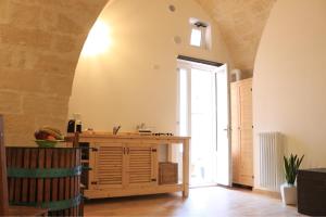 a kitchen with a wooden counter in a room at La dimora di Enzo in Matera