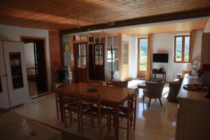 a dining room and living room with a table and chairs at La Truelle in Seyne