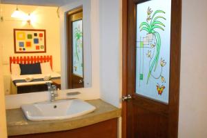 a bathroom with a sink and a mirror and a bed at Selagala Resort in Anuradhapura