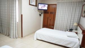 Ένα ή περισσότερα κρεβάτια σε δωμάτιο στο Hotel Gramado de Campos