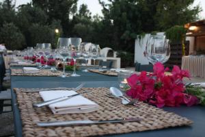 a long table with plates and glasses and flowers on it at Anassa in Polis Chrysochous