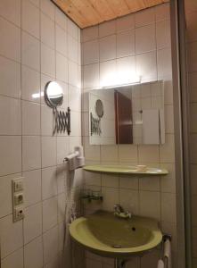 a bathroom with a green sink and a mirror at Hotel B&B Steinasäge in Bonndorf im Schwarzwald +28 photos