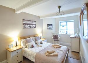a bedroom with a bed and a chair and a window at Host & Stay - View Point Apartment in Hinderwell