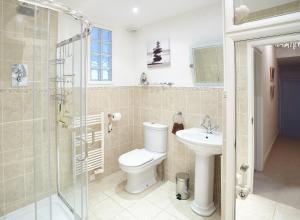 a bathroom with a toilet and a sink and a shower at Host & Stay - View Point Apartment in Hinderwell