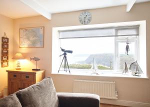 a living room with a window with a view of the ocean at Host & Stay - View Point Apartment in Hinderwell