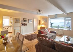 a living room with a couch and a table at Host & Stay - View Point Apartment in Hinderwell