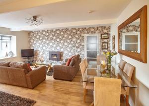 a living room with a couch and a table at Host & Stay - View Point Apartment in Hinderwell