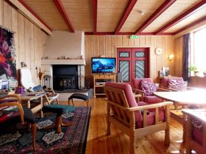 a living room filled with furniture and a tv at Tronsvangen Seter in Alvdal