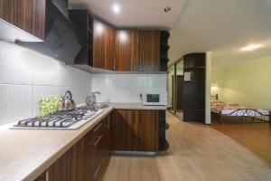 a kitchen with a stove top oven in a room at Iordanska Street Apartments in Kyiv
