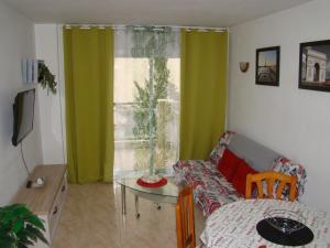 a living room with a couch and a table at Apartamento Cap de Salou in Salou