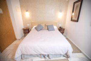Кровать или кровати в номере Hotel Nómadas