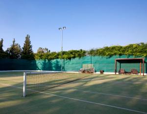 a tennis court with a net on a tennis court at Anassa in Polis Chrysochous