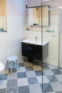 a bathroom with a sink and a toilet and a stool at Haus Ambiente in Reil