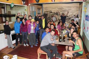 a group of people posing for a picture in a room at Patagonia House in Punta Arenas