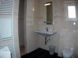 a bathroom with a sink and a toilet at Hotel Kurpfalz in Speyer