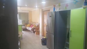 a kitchen with a refrigerator and a living room at Piso lujoso in Puerto de Mazarrón