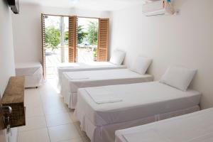 A bed or beds in a room at Hotel Pousada Recanto do Pai