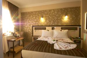 a hotel room with a bed and a desk and a bedroom at Soyic Hotel in Eskisehir