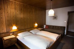 um quarto com uma cama e um sofá em Residence Rienz em Chienes