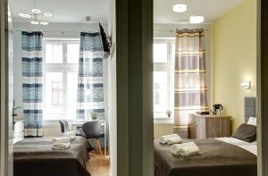 Postel nebo postele na pokoji v ubytování Grace Apartments