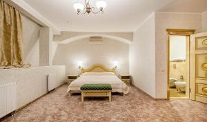 A bed or beds in a room at Veles Hotel