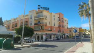 a building with a sign on top of it on a street at Apartamento Nerja Beach in Nerja