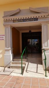 a front door of a building with green poles in front at Apartamento Nerja Beach in Nerja