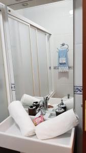 a white bathroom with a sink and a mirror at Apartamento Nerja Beach in Nerja